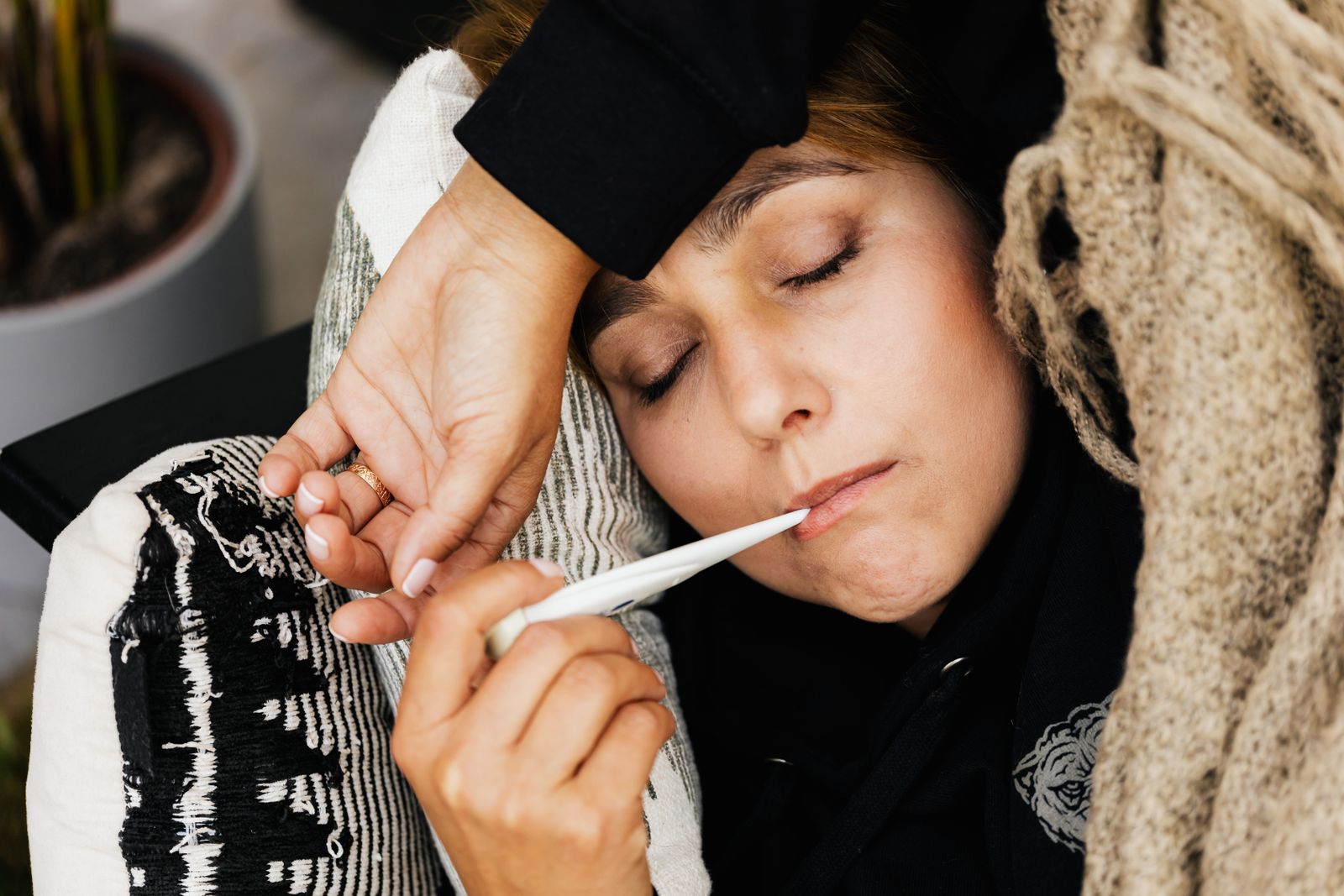A parent checking a child's temperature at home